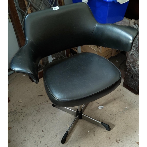 489 - A modernist designer (possibly Danish) leather effect and chrome swivel arm chair in black.