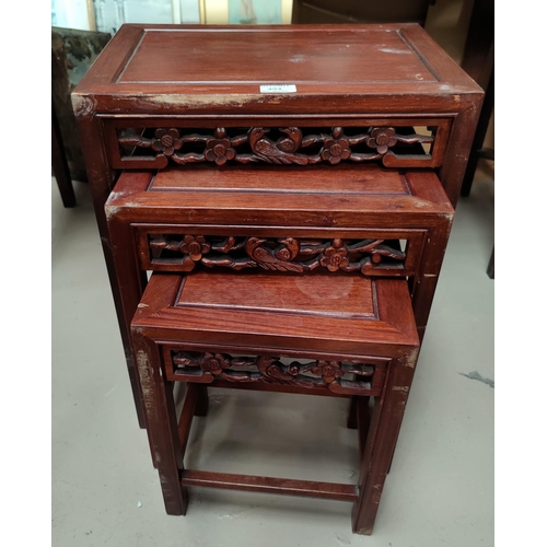 494 - A modern Chinese nest of four stained wood occasional tables
