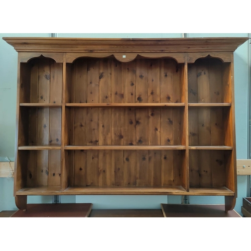 506 - An oak three height bookcase; a modern pine Delft rack