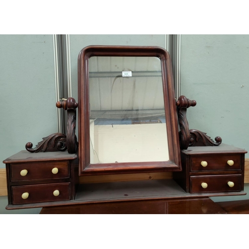 525 - A Victorian dressing table mirror the mahogany frame with carved brackets and 4 drawers