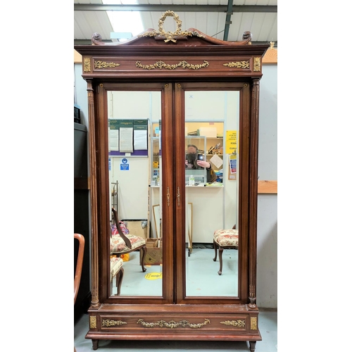 499 - A late 19th/early 20th century Louis XV1 style mahogany  wardrobe enclosed by two beveled mirror doo... 