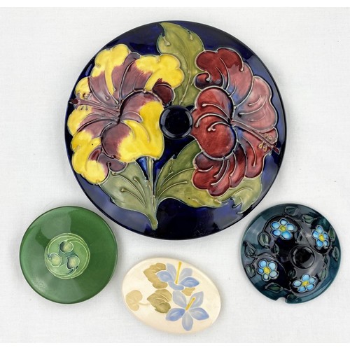 151 - A Moorcroft powder bowl lid Hibiscus pattern, diameter 17cm; 3 other smaller Moorcroft trinket pot l... 