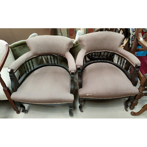 528 - An Edwardian pair of tub shaped ebonised armchairs in brown fabric