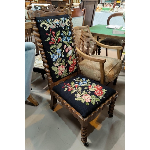 535 - A Victorian walnut low seat chair with high back and barleytwist columns and legs,  in needlework   ... 