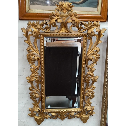 652 - A 19th century highly decorative rectangular bevelled edge wall mirror in carved and gilded Florenti... 