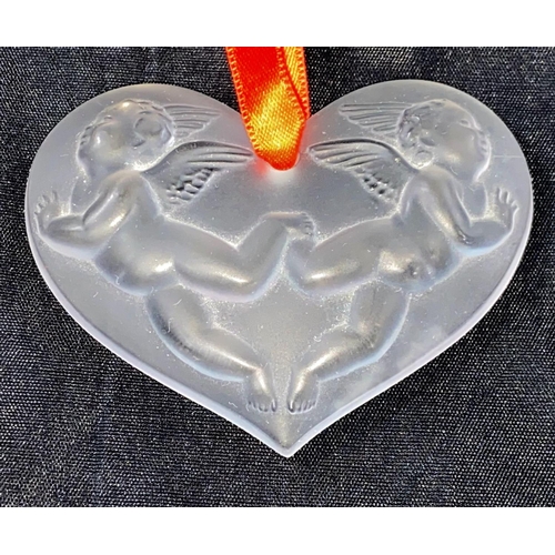 382 - A modern Lalique originally boxed heart, decorated with cherubs in relief, signed Lalique France.