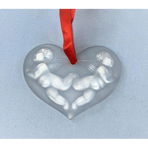 382 - A modern Lalique originally boxed heart, decorated with cherubs in relief, signed Lalique France.