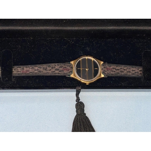 412 - An originally cased lady's Yves Saint Laurent Collection wristwatch on original woven strap, gilt ca... 