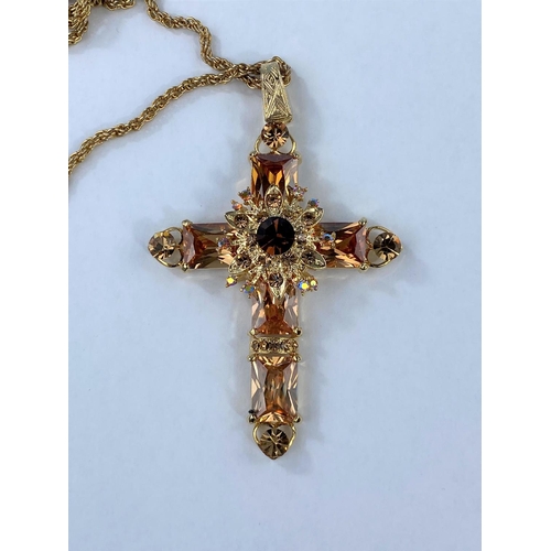 466 - A stylized gilt and amber coloured stones on gilt effect chain; a multi-coloured stoned butterfly br... 