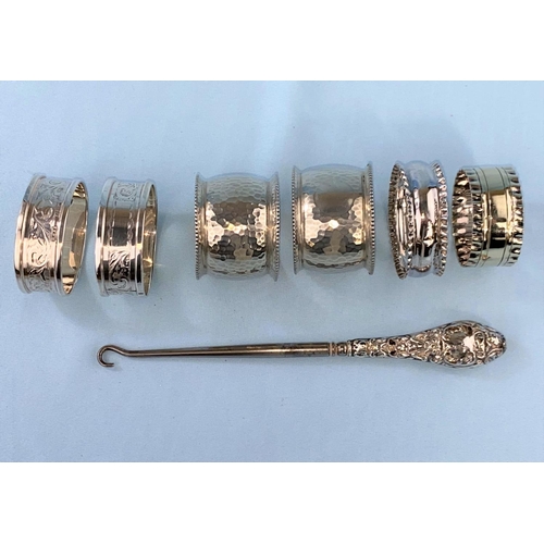 505 - A hallmarked silver posy vase: a pair of hallmarked silver napkin rings, two others and a button hoo... 