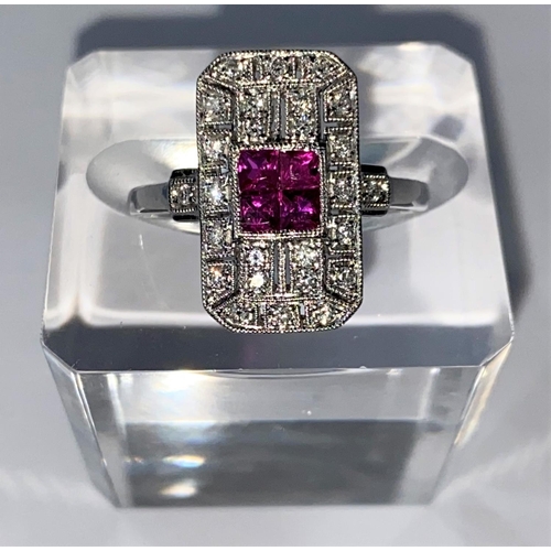 439 - An Art Deco style white metal ruby & diamond ring, comprising of 4 baguette cut rubies surrounded by... 