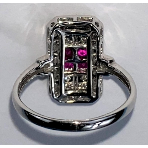 439 - An Art Deco style white metal ruby & diamond ring, comprising of 4 baguette cut rubies surrounded by... 