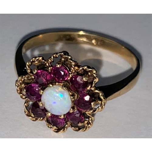 440 - A vintage opal & almondine garnet yellow gold cluster ring, comprising of a central round opal surro... 