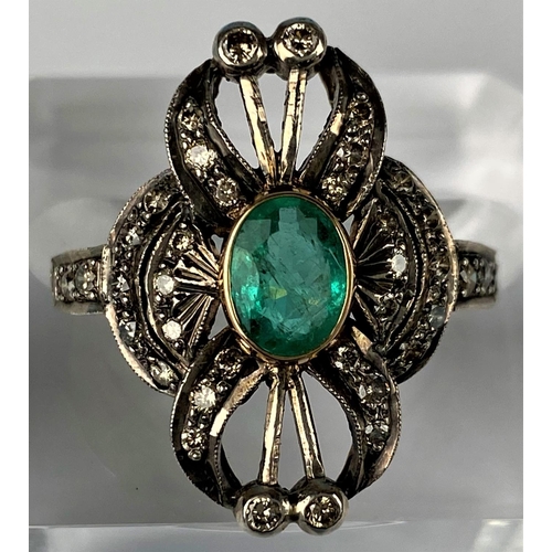 441 - An early 20th century emerald & diamond ring comprising of a central oval emerald with 38 diamonds i... 