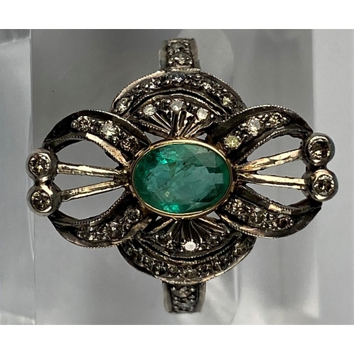 441 - An early 20th century emerald & diamond ring comprising of a central oval emerald with 38 diamonds i... 