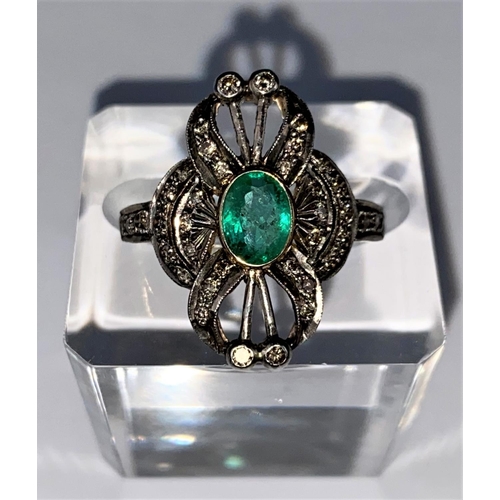 441 - An early 20th century emerald & diamond ring comprising of a central oval emerald with 38 diamonds i... 