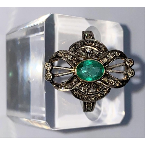 441 - An early 20th century emerald & diamond ring comprising of a central oval emerald with 38 diamonds i... 