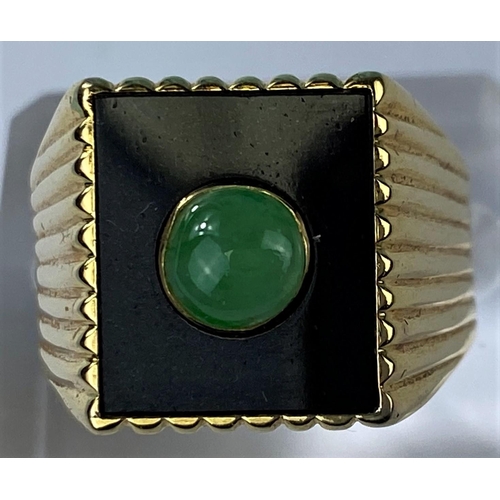 475 - A yellow metal gent's signet ring set with square jet coloured base with central jade coloured domed... 