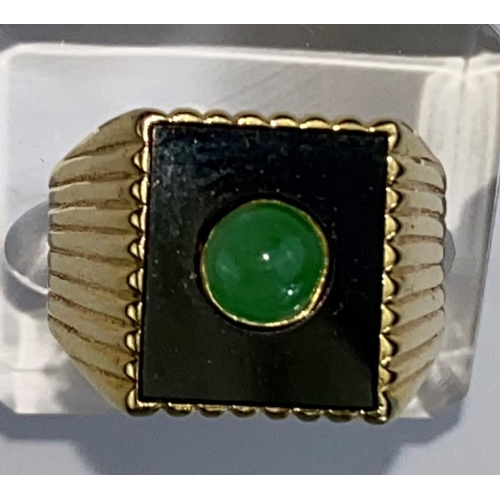 475 - A yellow metal gent's signet ring set with square jet coloured base with central jade coloured domed... 