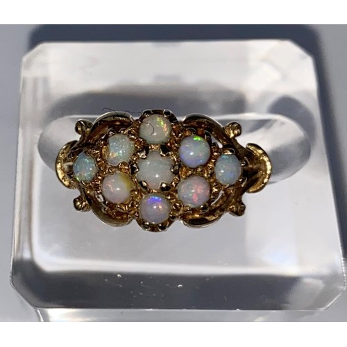 419 - A 9 carat hallmarked gold dress ring set 9 opal coloured stones, 3 gm, size K (1 stone slight chip)