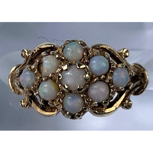 419 - A 9 carat hallmarked gold dress ring set 9 opal coloured stones, 3 gm, size K (1 stone slight chip)