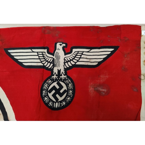154 - A German WWII era flag, with perhaps contemporary damage.  Size: 182cm x 104cm