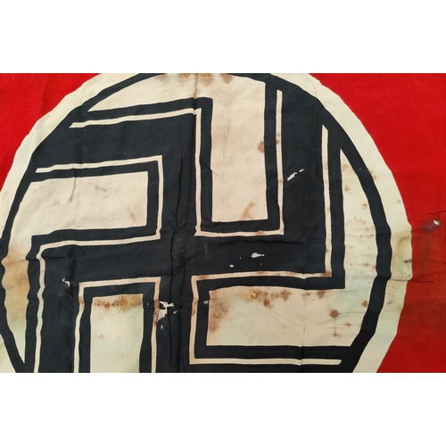 154 - A German WWII era flag, with perhaps contemporary damage.  Size: 182cm x 104cm