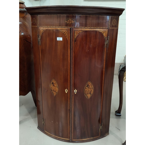 556 - A mahogany Sheraton inlaid corner cabinet.