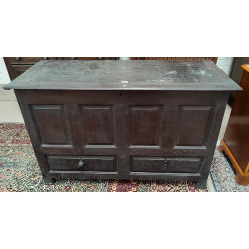 563 - An 18th century oak framed and panelled mule chest, with 4 fielded front panels over 2 drawers