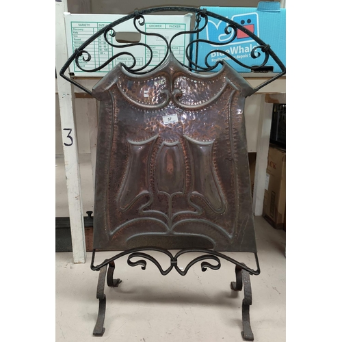 57 - An Art Nouveau firescreen in beaten copper and wrought iron; a mirror firescreen