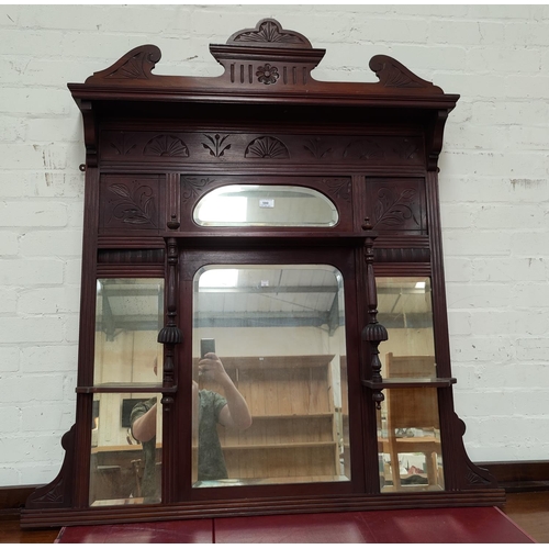 580 - An Edwardian overmantel mirror in carved mahogany frame