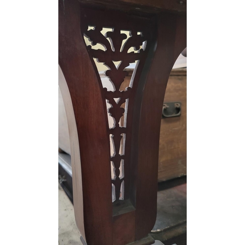 591 - A Victorian mahogany side table/washstand with 3 frieze drawers, pierced end supports, on scroll fee... 