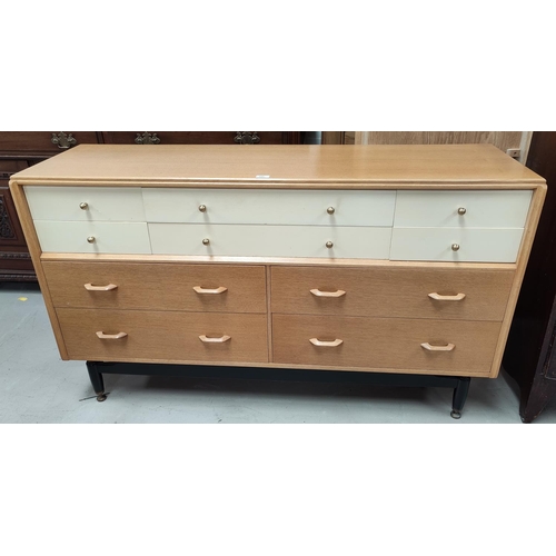 598 - A 1960's G-Plan chest of 4 deep and 6 small drawers in light oak and white laminate, width 150 cm; a... 