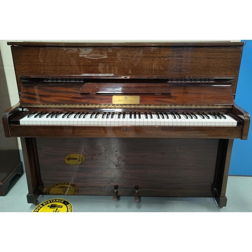 600 - A modern small piano in mahogany case, iron framed and overstrung, by John Broadwood & Sons, with bo... 