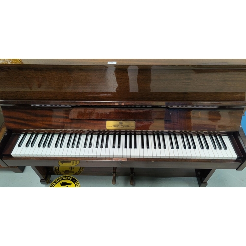 600 - A modern small piano in mahogany case, iron framed and overstrung, by John Broadwood & Sons, with bo... 