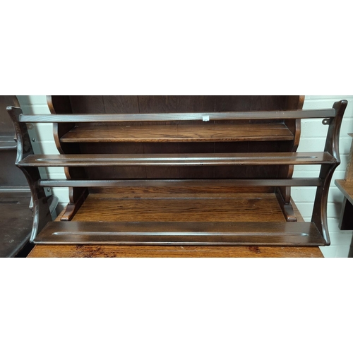 607 - An Ercol dark oak pair of delft racks