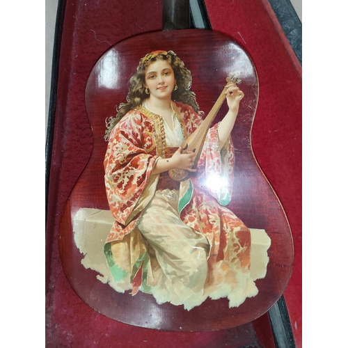 62 - An Anglo-Neapolitan guitar shaped mandolin with portrait to the reverse, cased