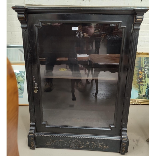 626 - A Victorian ebonised empire style pier cabinet with single glazed display door, incised gilt decorat... 