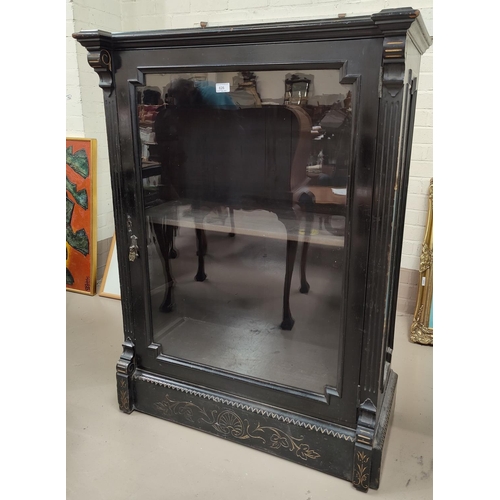 626 - A Victorian ebonised empire style pier cabinet with single glazed display door, incised gilt decorat... 