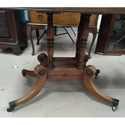 647 - An early 19th century mahogany card table with canted foldover top, on 4 turned columns, splay feet ... 