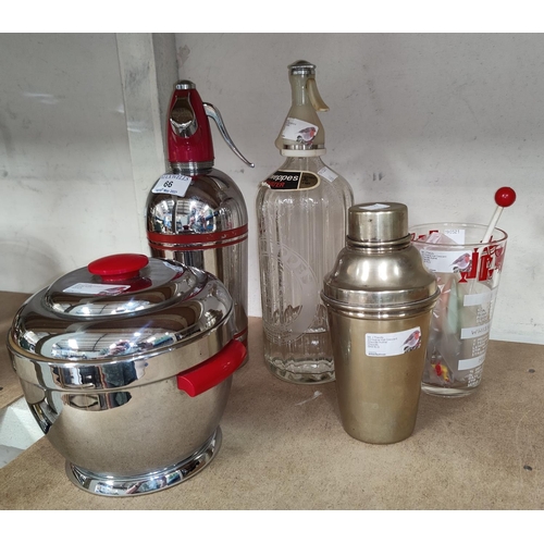 66 - A 1930's style chrome soda siphon and ice bucket; a silver plated cocktail shaker; a Guinness 'Totem... 