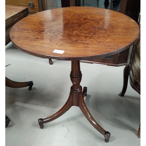 667 - An early a9th century mahogany coffee table with circular top, on turned column and 3 splay feet