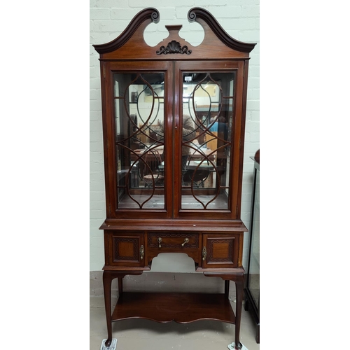 669 - A Georgian style mahogany display cabinet with swan neck pediment, 2 glazed doors over 3 drawers and... 