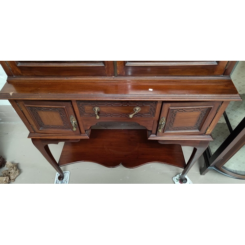 669 - A Georgian style mahogany display cabinet with swan neck pediment, 2 glazed doors over 3 drawers and... 