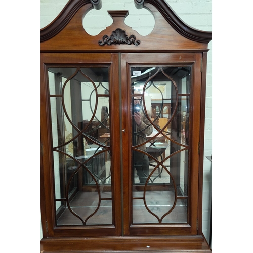 669 - A Georgian style mahogany display cabinet with swan neck pediment, 2 glazed doors over 3 drawers and... 