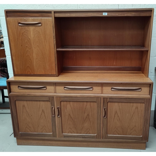 680 - A mid 20th century teak G-Plan side unit having 3 cupboards, 3 drawers, pull down cupboard above wit... 