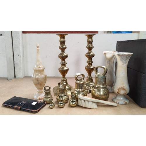 70 - A set of 7 butcher's brass bell weights; 3 marble vases; a pair of candlesticks; etc.