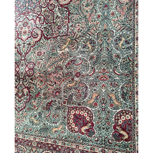 713 - An impressive large Middle Eastern style carpet, fawn ground with geometric decoration and animals e... 