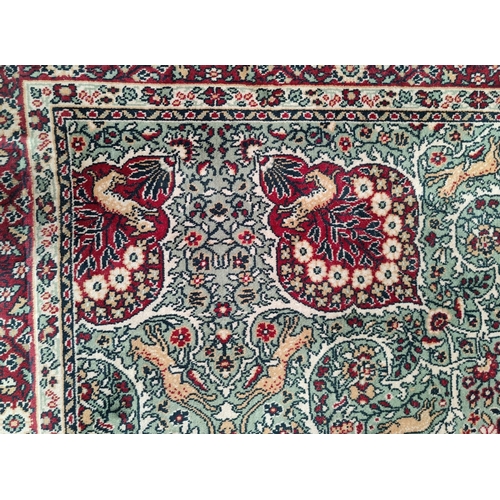 713 - An impressive large Middle Eastern style carpet, fawn ground with geometric decoration and animals e... 