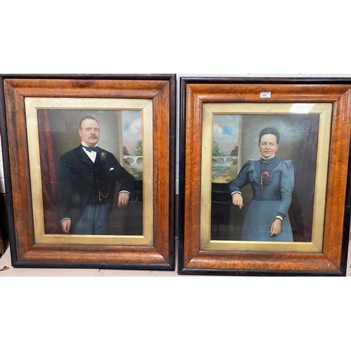 524 - A pair of bird's eye maple veneered frames containing three quarter length overpainted portraits of ... 